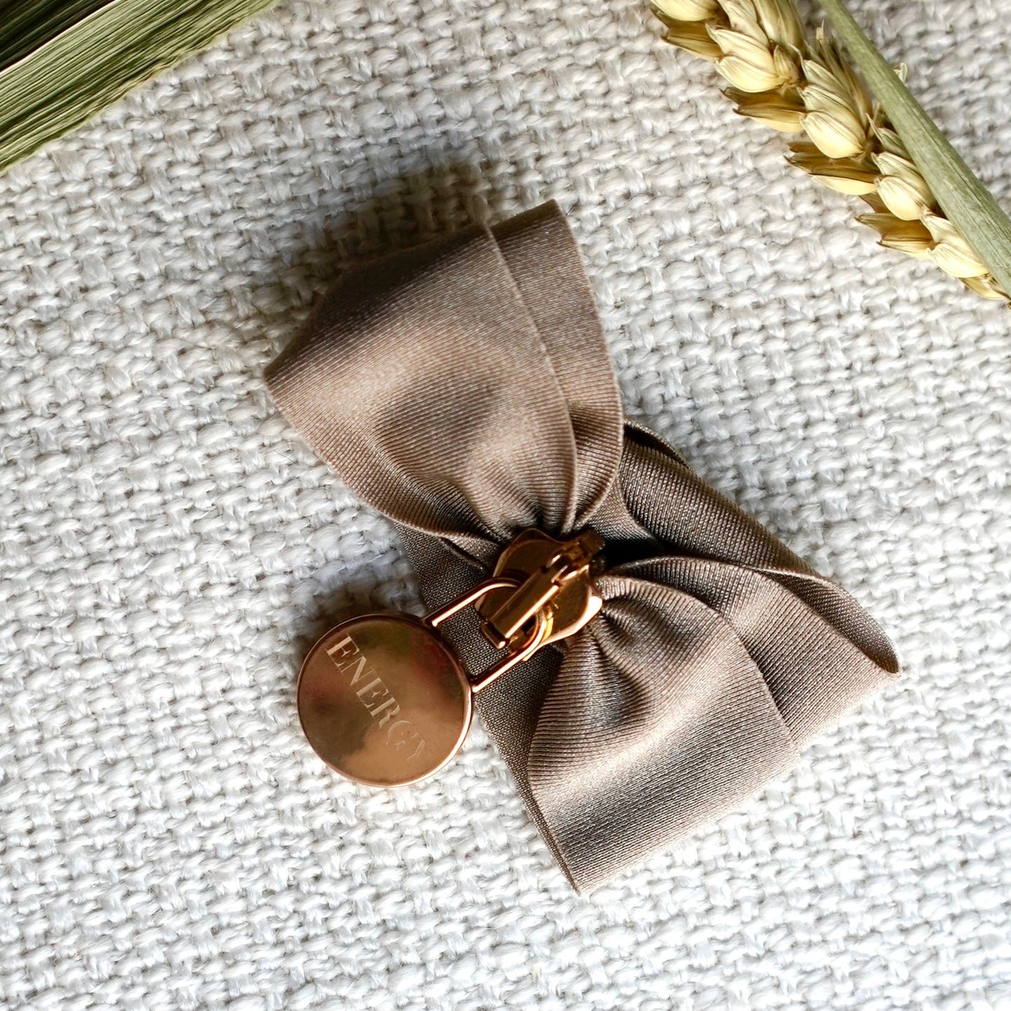 Engraved energy bracelet with brown fabric bow and round metal tag, handcrafted in Italy for mindfulness and energy alignment