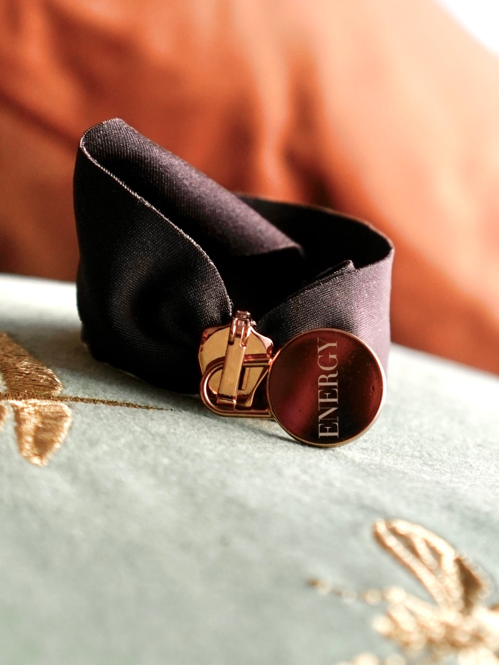 Engraved energy bracelet with black band and gold clasp handcrafted in Italy for mindfulness and energy alignment