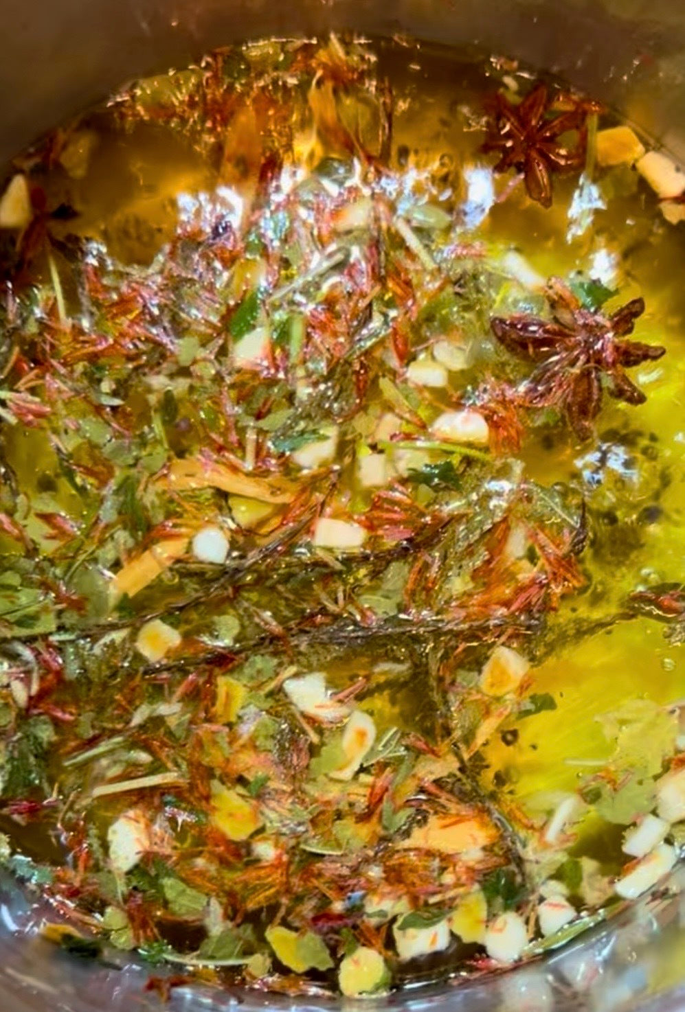 EverKindle - Kindle Simmer Autumn Incense burning with star anise, burnt orange peel, juniper, and mallow flower herbs in golden liquid