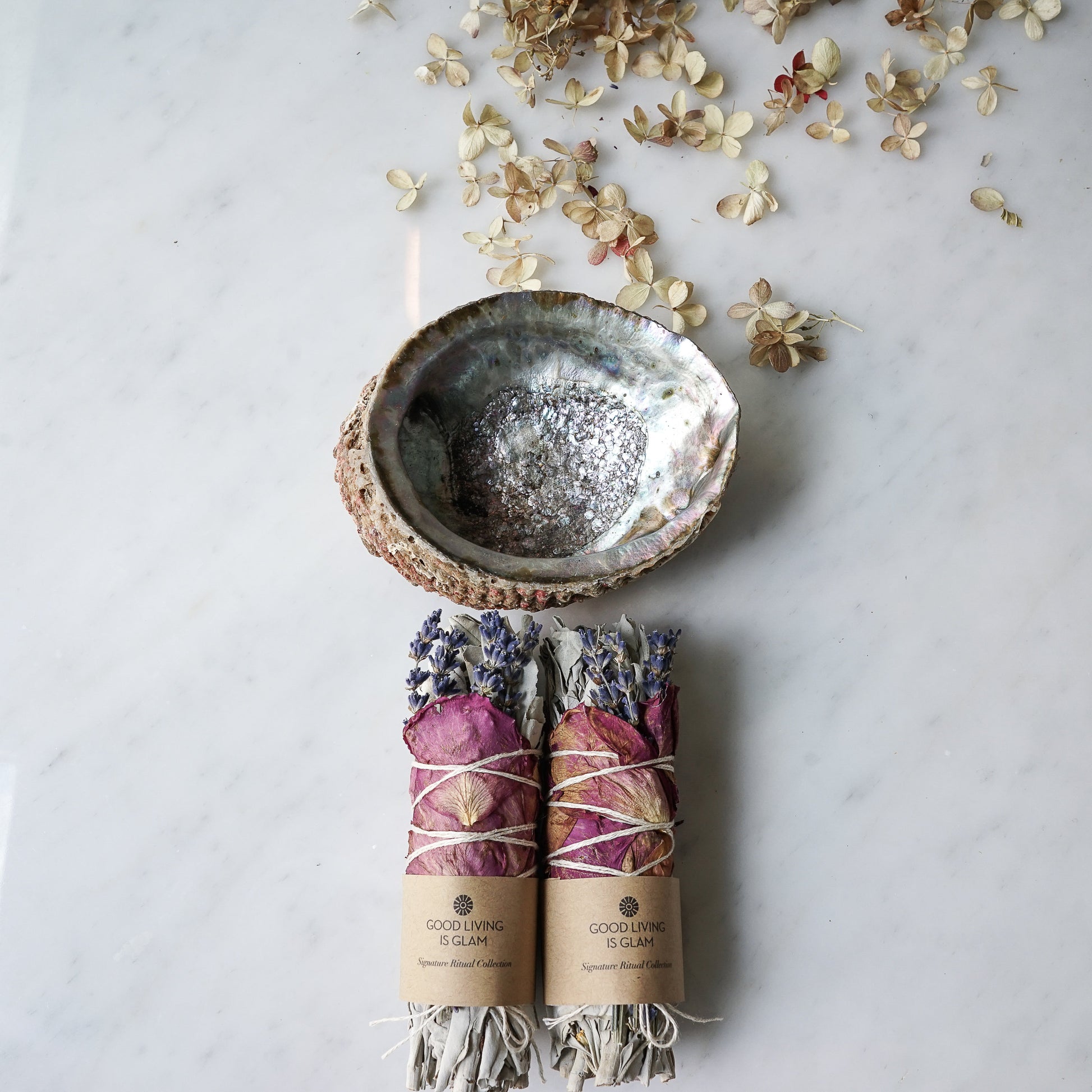 Inspiriting Rose Lavender Herbal Incense Bundle with dried rose, lavender, and smudging ash bowl on marble background