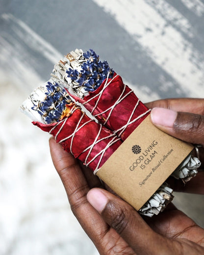 A pack of 2 sage smudge sticks held in hands